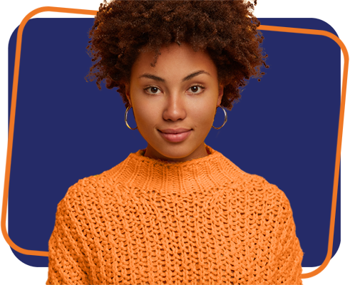 Portrait of Afro American millennial woman with calm serious face expression, looks directly at camera, wears knitted jumper, has natural beauty