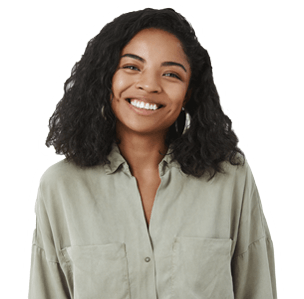 Waist-up shot of cute friendly-looking pleasant African American female friend with curly hairstyle in trendy blouse tilting head smiling joyfully and looking with warm tender expression at camera.