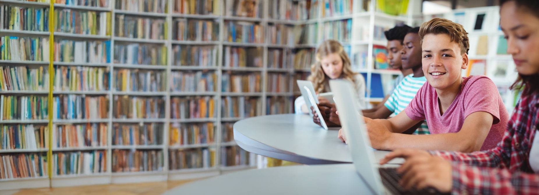 Student with a laptop in a library