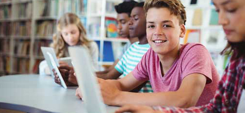 Student with a laptop in a library