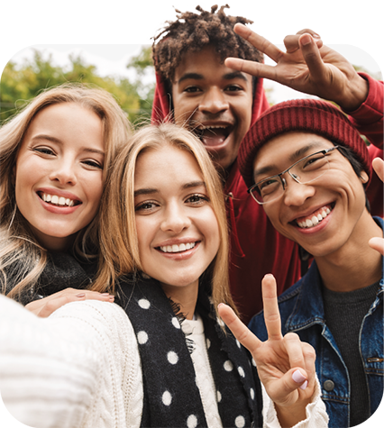 Four students smiling at the camera